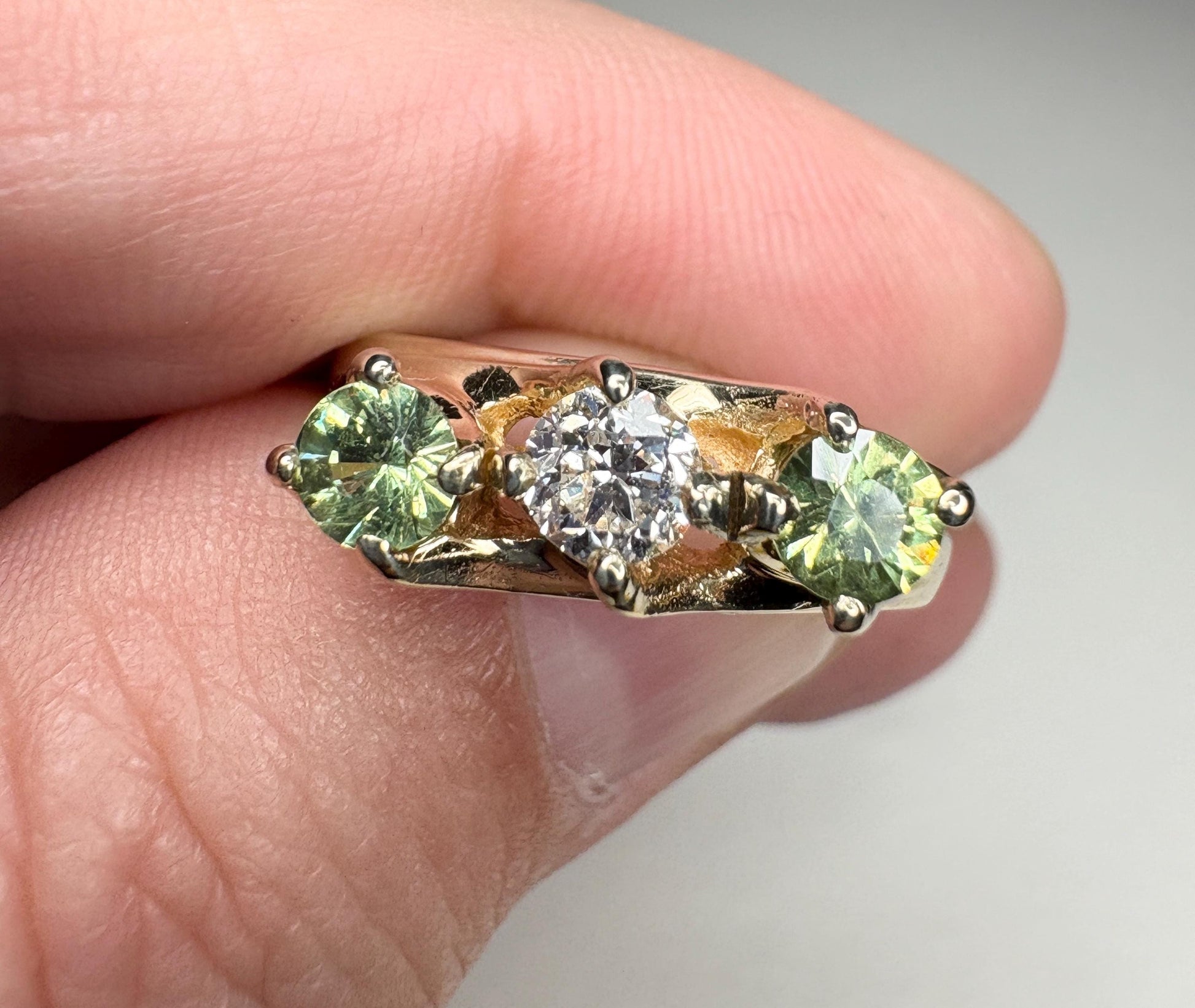 Vintage 10k gold ring with a diamond and two demantoid garnets.