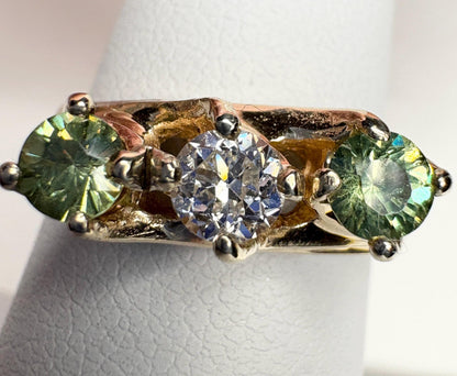 Vintage 10k gold ring with a European cut diamond and two demantoid garnets.