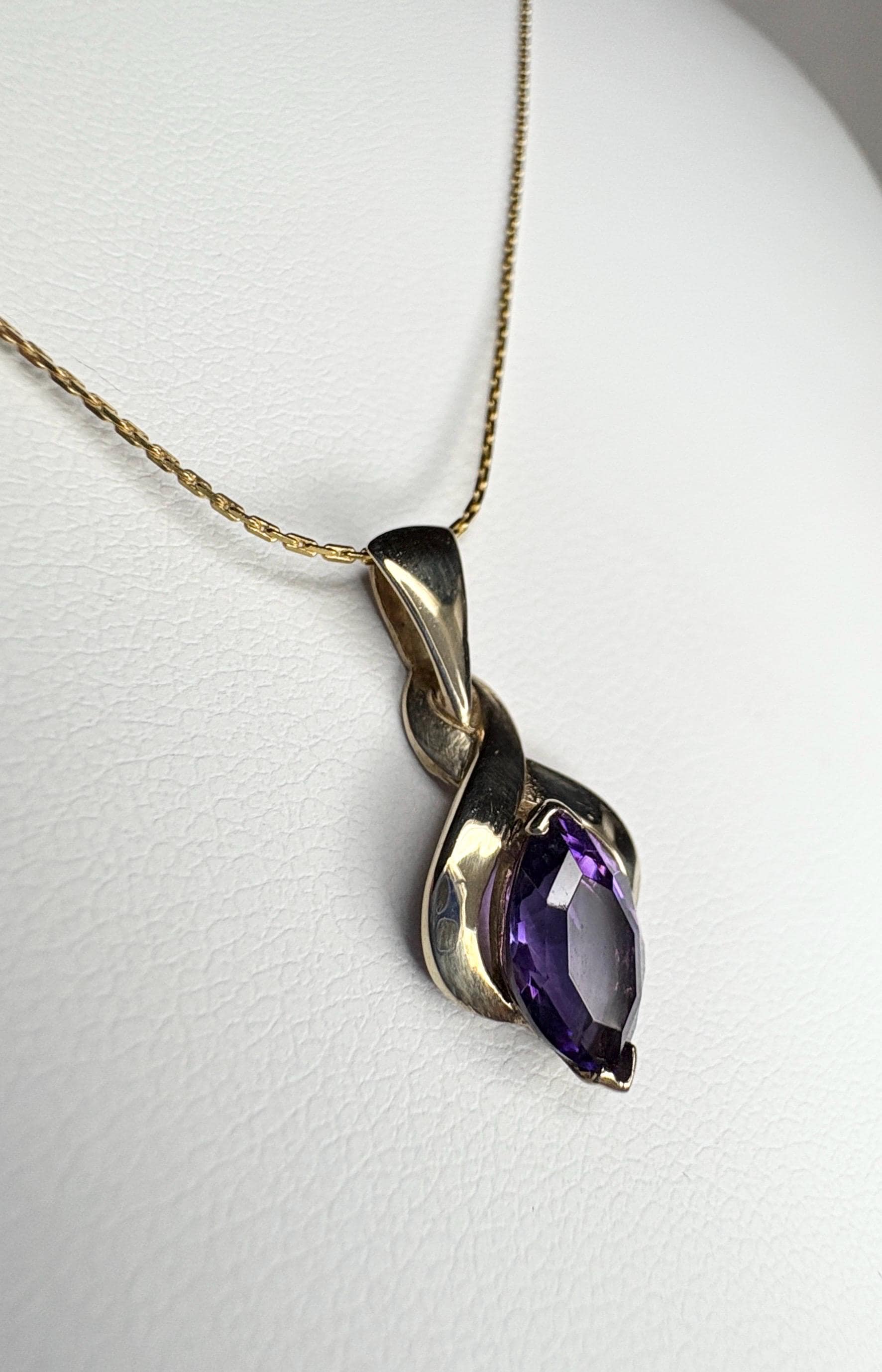 Vintage 9k gold pendant necklace with a marquise-cut amethyst.