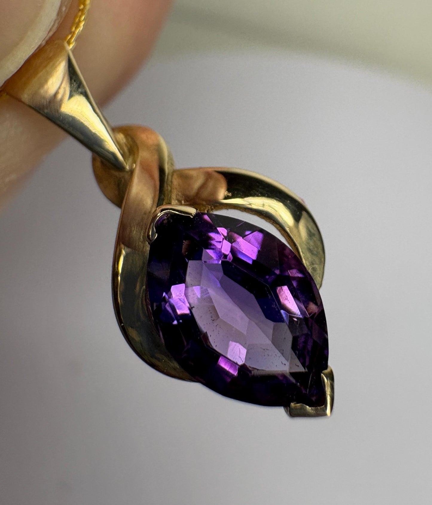 Vintage 9k gold pendant with a marquise-cut amethyst on an 18" chain.