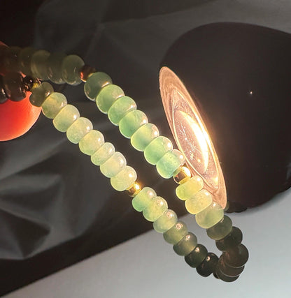 Guatemalan Type A jadeite jade stretch bracelet with gold beads.