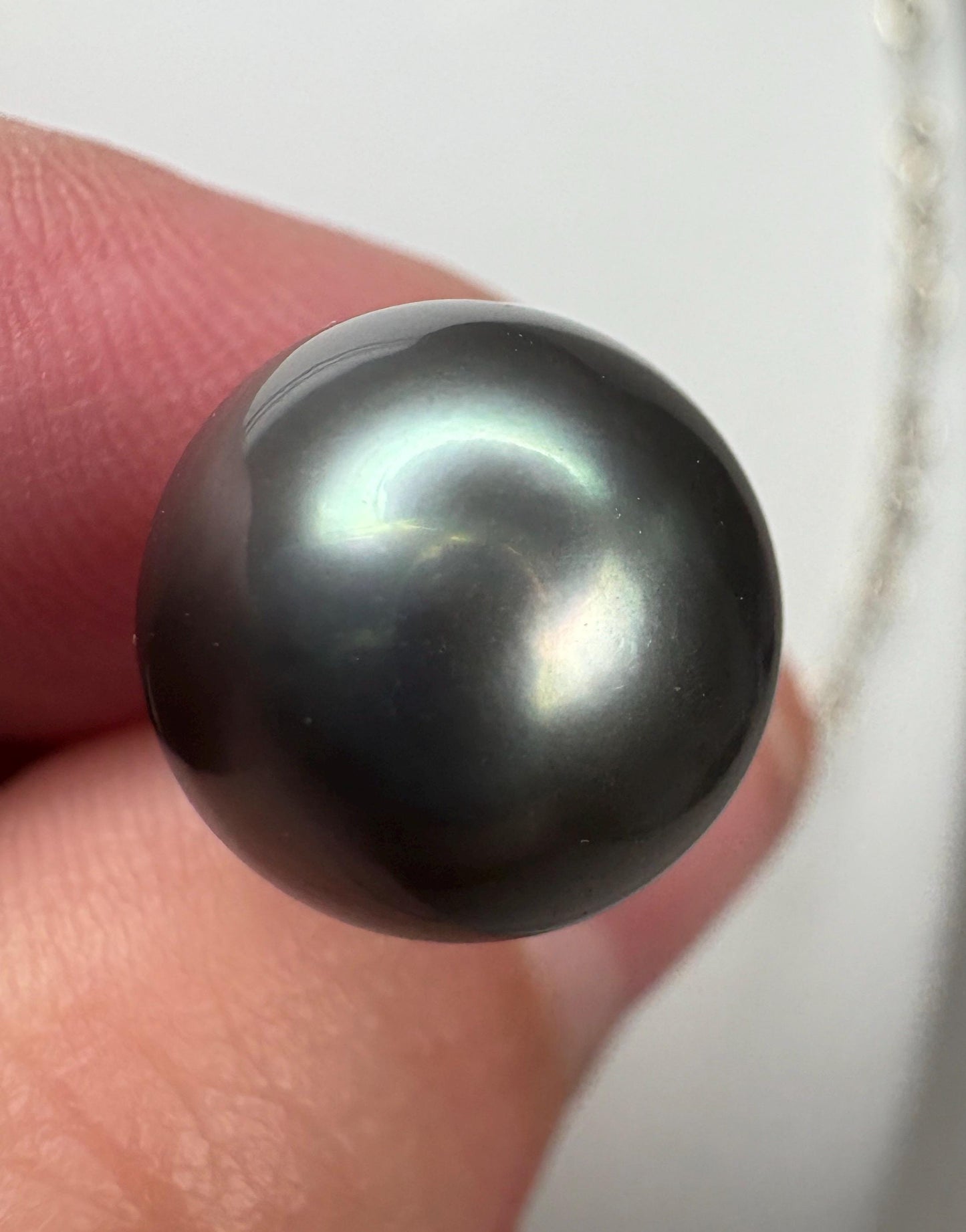 A 12mm Tahitian cultured pearl pendant on a 20-inch James Avery figaro chain.