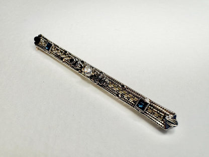 Antique bar brooch with old mine cut diamond and simulated sapphires in 10k white gold.