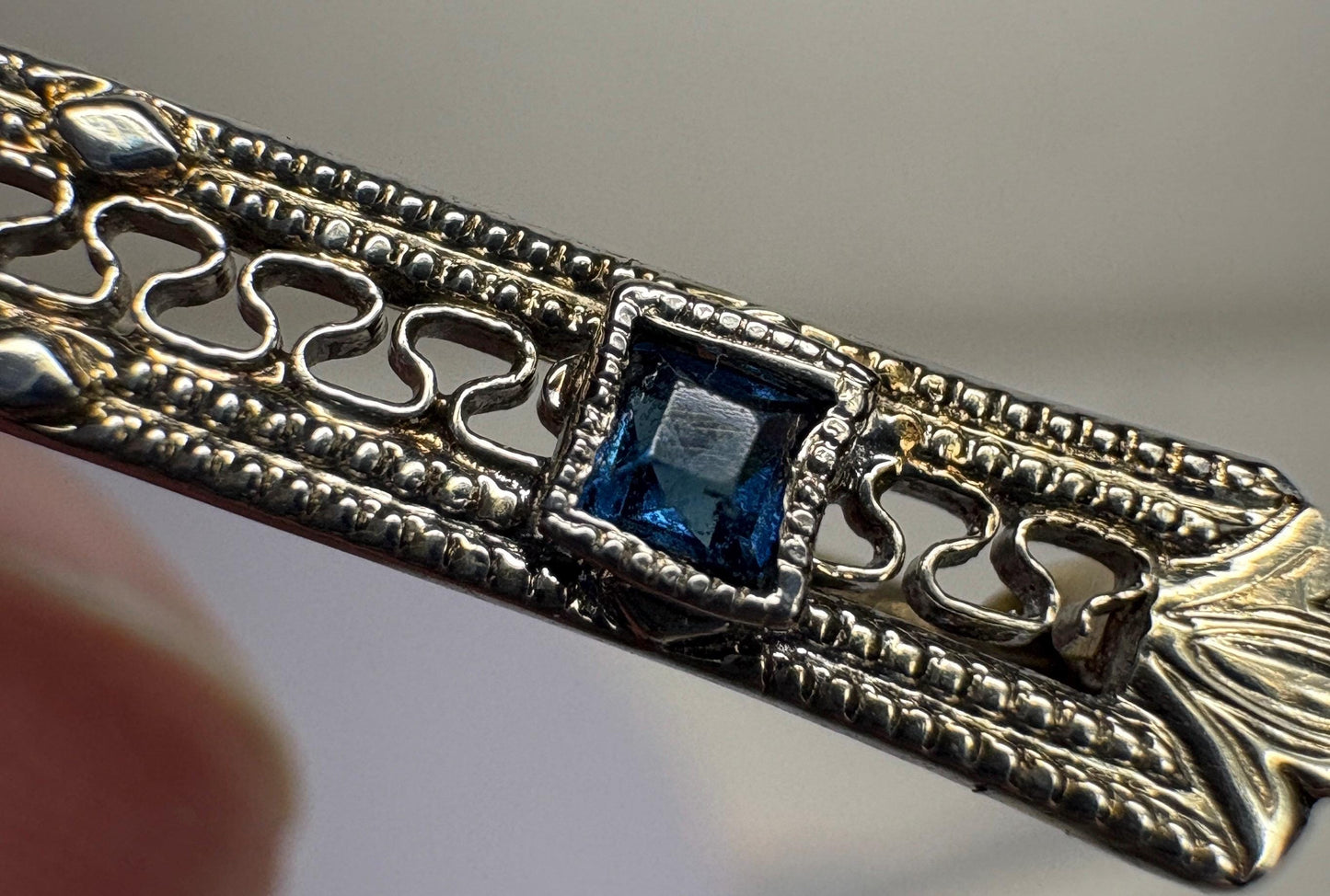 Antique 10k white gold bar brooch with a diamond and simulated sapphires.