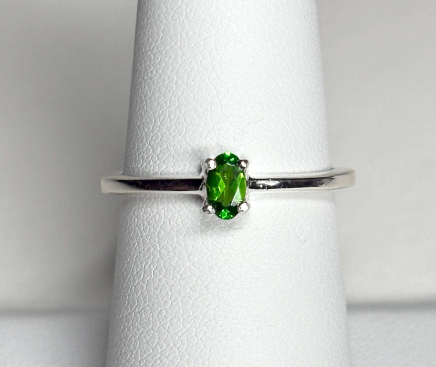 Sterling silver ring with a 3x5mm oval chrome diopside gemstone.