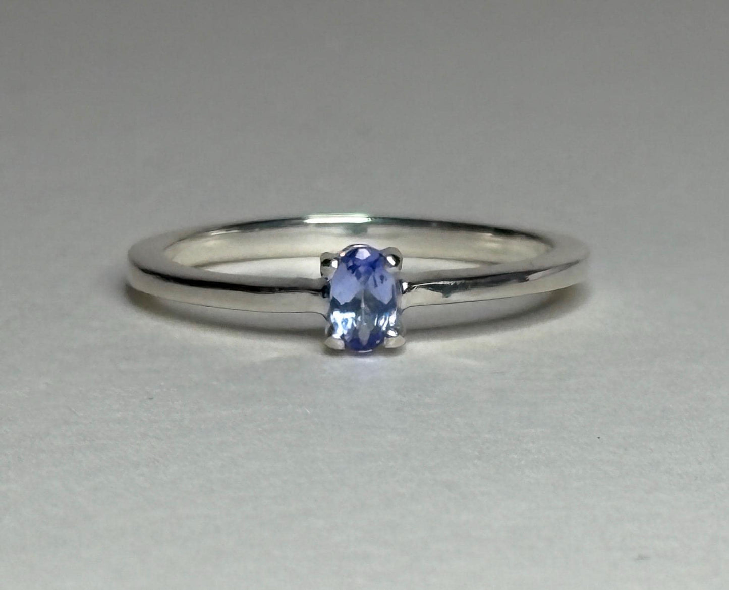 Sterling silver ring with a 5x3mm oval tanzanite gemstone.