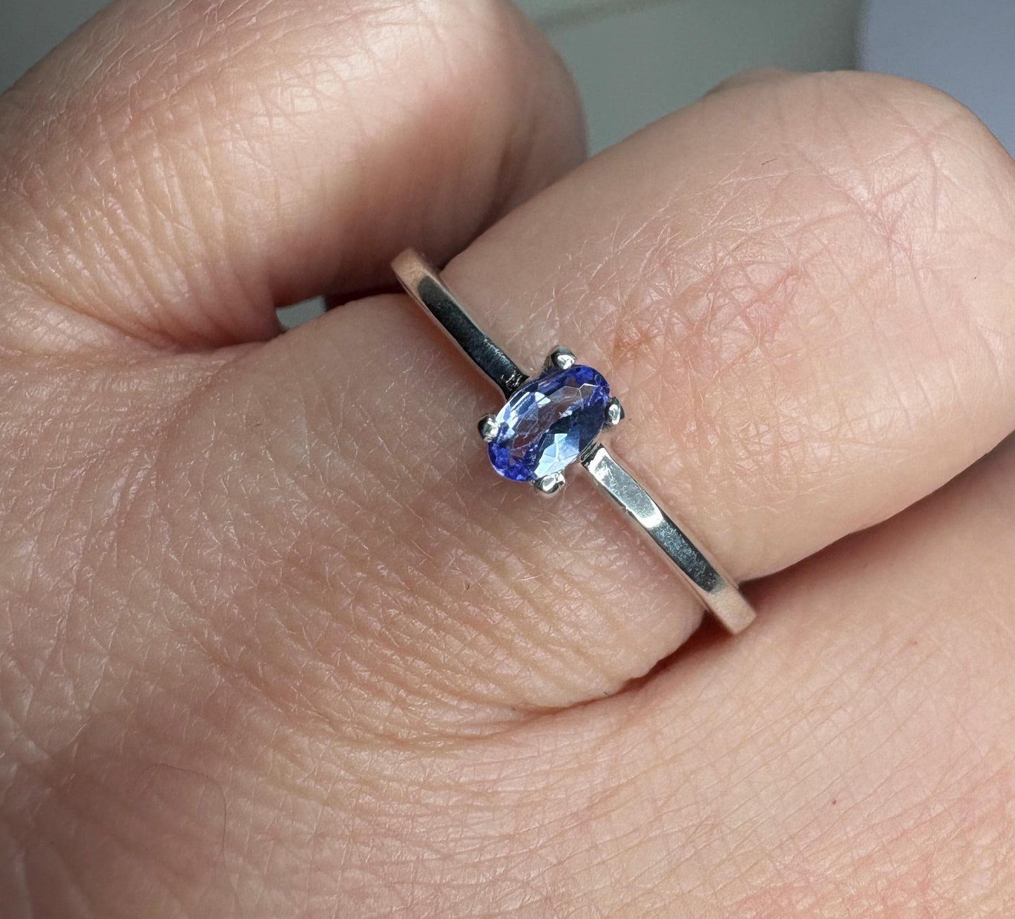 Sterling silver ring with a 5x3mm oval tanzanite gemstone.