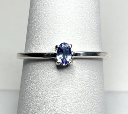Sterling silver ring with a small oval tanzanite gemstone.