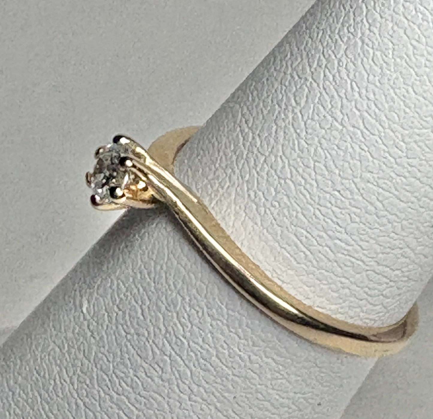 14k gold twist design solitaire ring with a natural diamond.