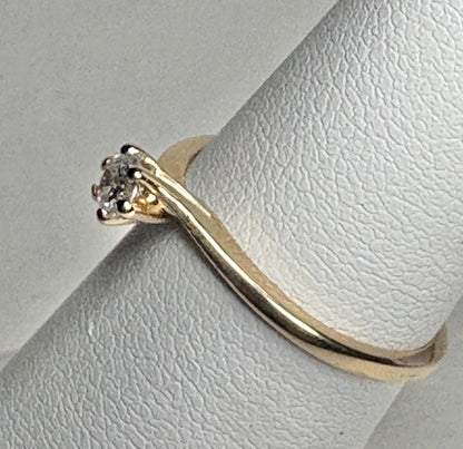 14k gold twist design solitaire ring with a natural diamond.