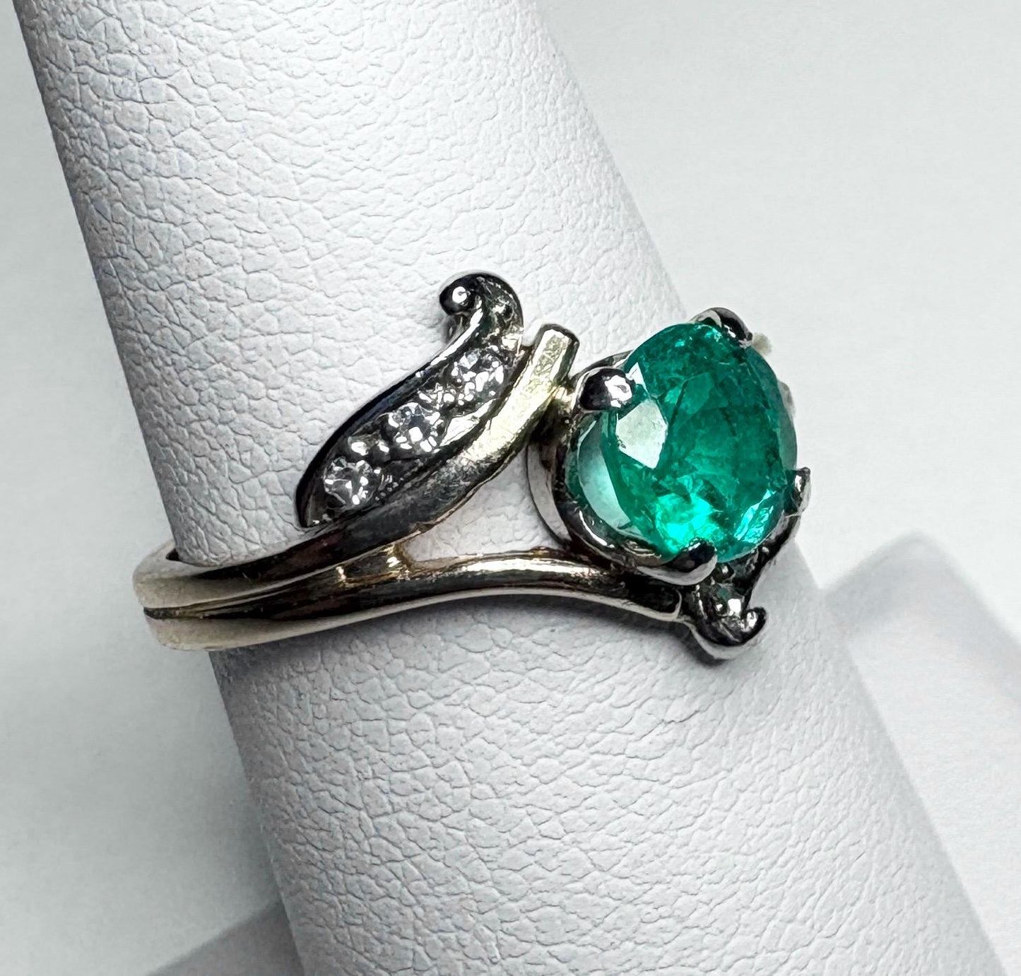 Vintage 14k gold ring with an oval emerald and single cut diamonds.