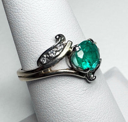 Vintage 14k gold ring with an oval emerald and single cut diamonds.