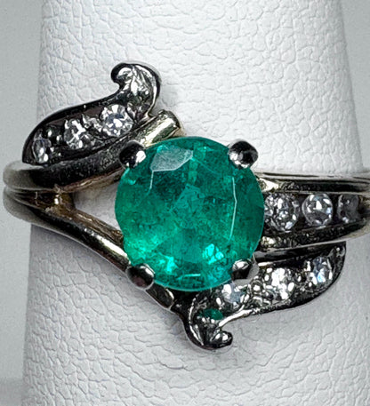 Vintage 14k gold ring with a free-form design, featuring an emerald and single cut diamonds.