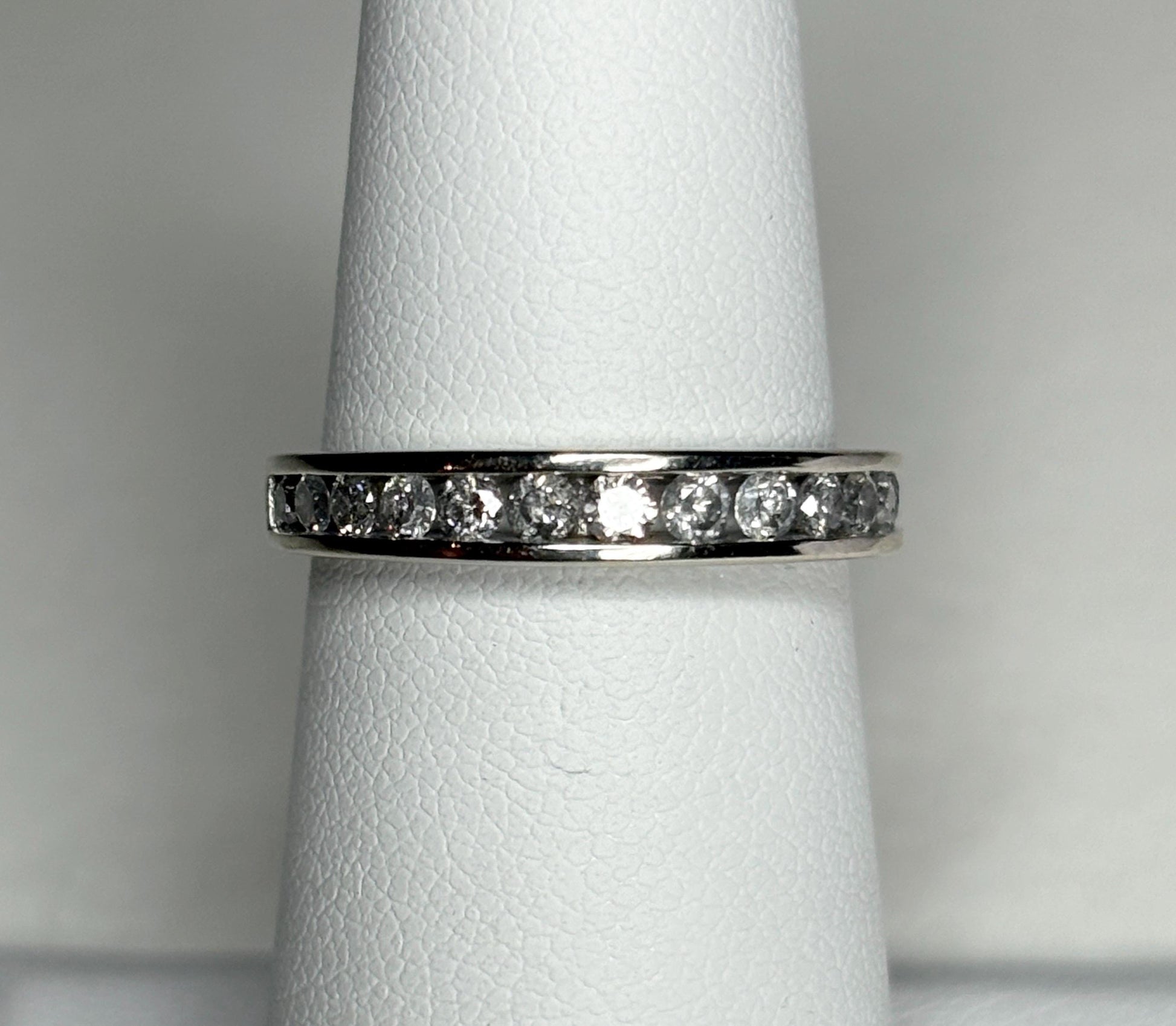 A white gold anniversary band ring with channel-set diamonds.