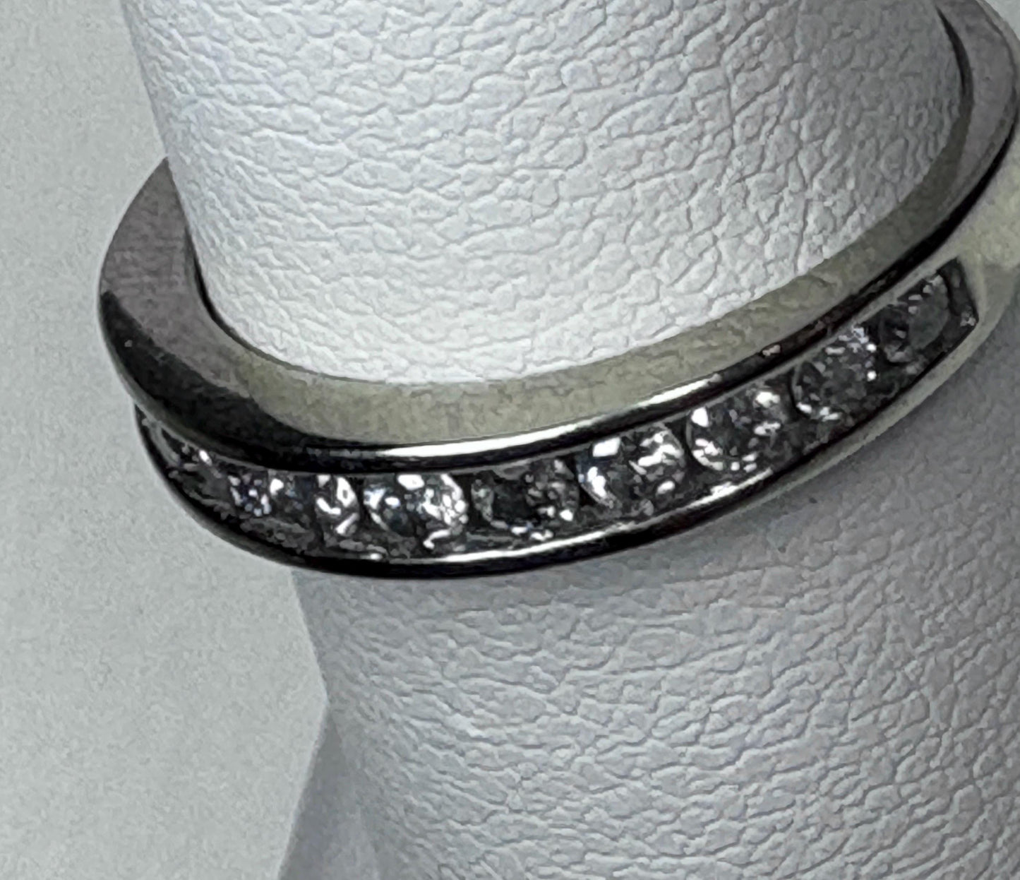 A white gold anniversary band ring with channel-set diamonds.
