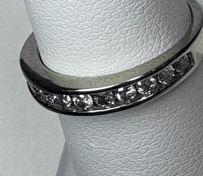 A white gold anniversary band ring with channel-set diamonds.