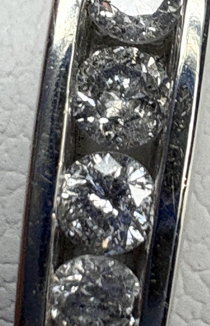 A white gold band ring with channel-set diamonds.