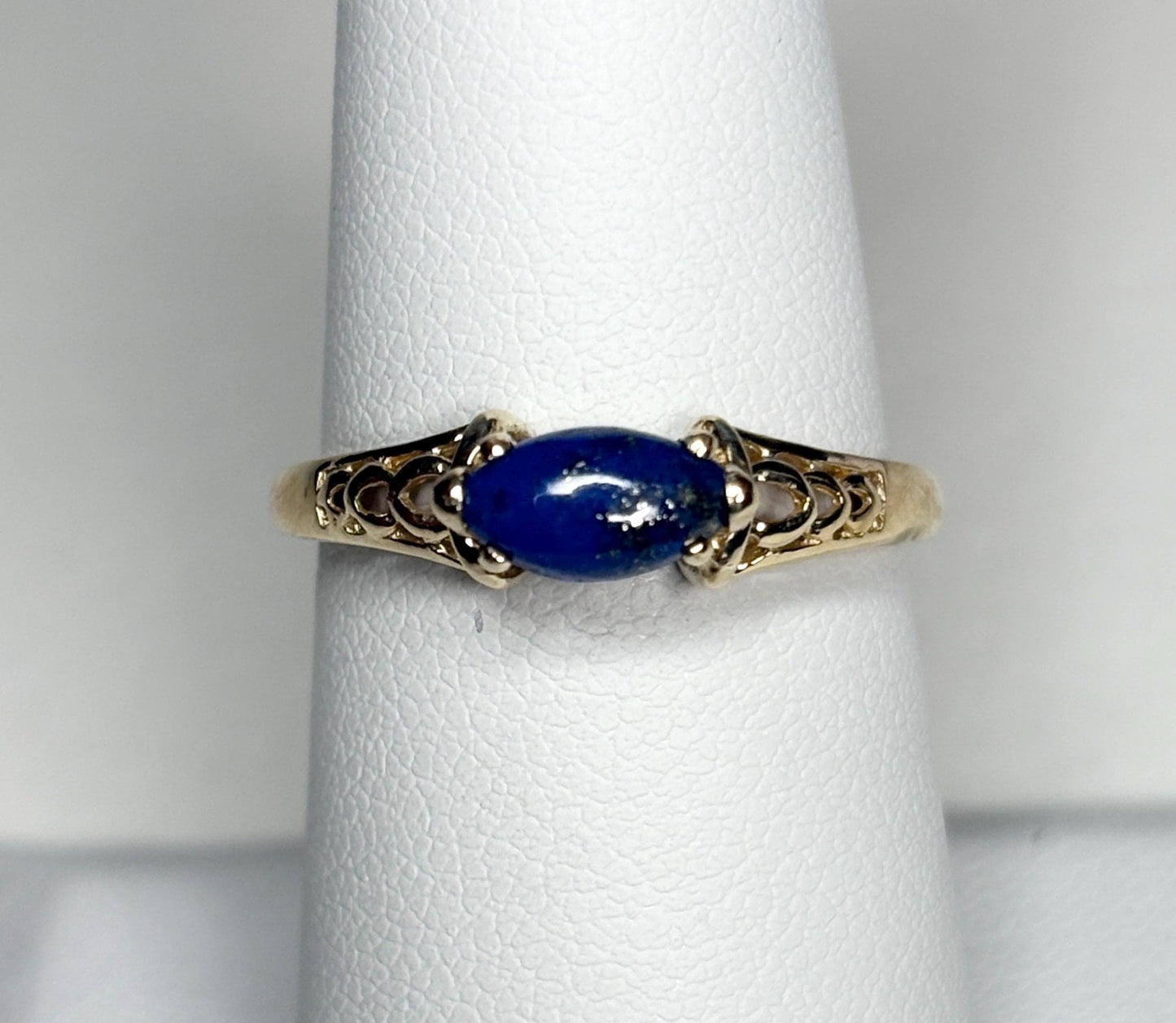 14k gold ring with a marquise lapis lazuli cabochon set east west.