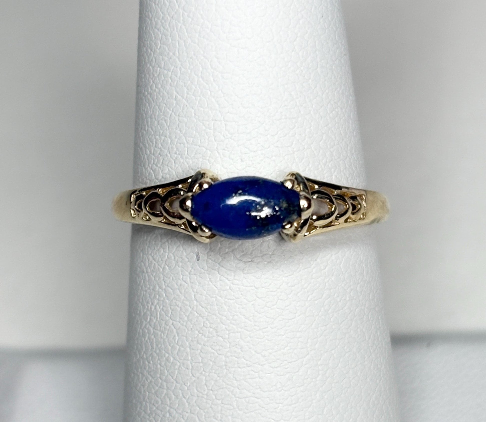 14k gold ring with a marquise lapis lazuli cabochon set east west.