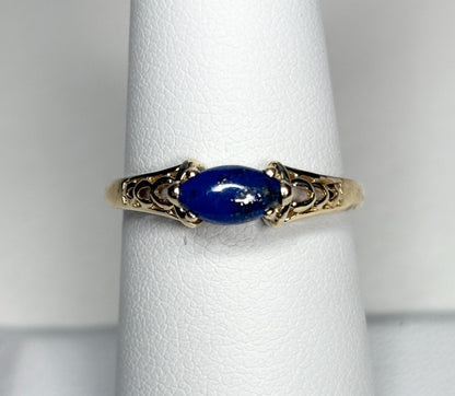 14k gold ring with a marquise lapis lazuli cabochon set east west.