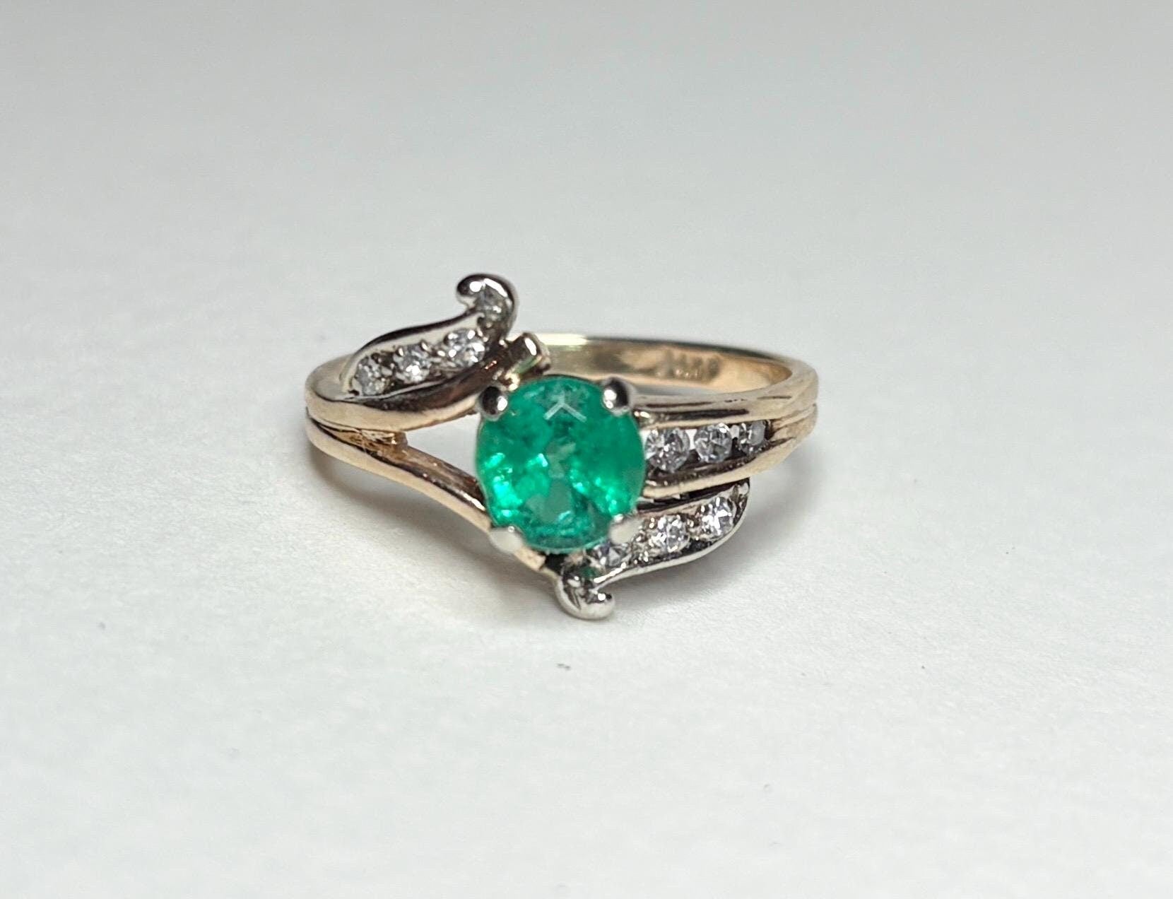 Vintage 14k gold ring with oval emerald and single cut diamonds.