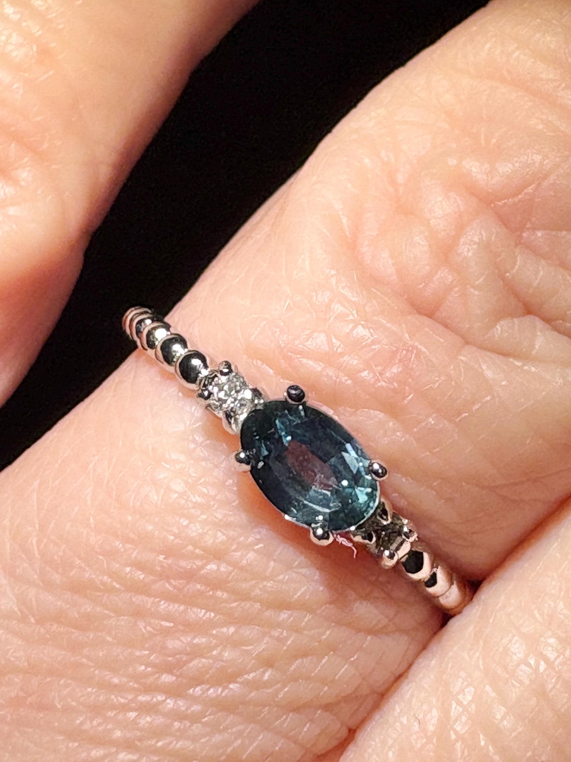 Sterling silver ring with oval Montana sapphire and diamonds on a beaded band.