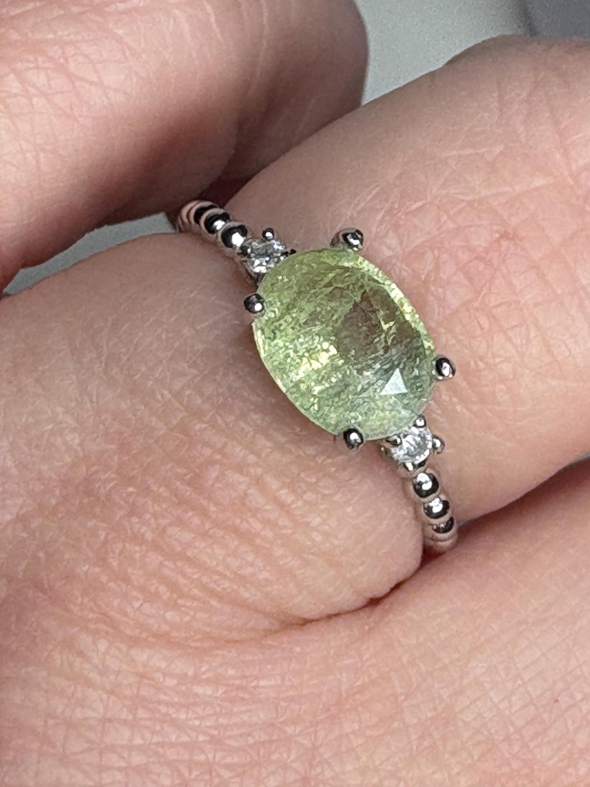 Sterling silver ring with a green cuprian tourmaline and diamonds.