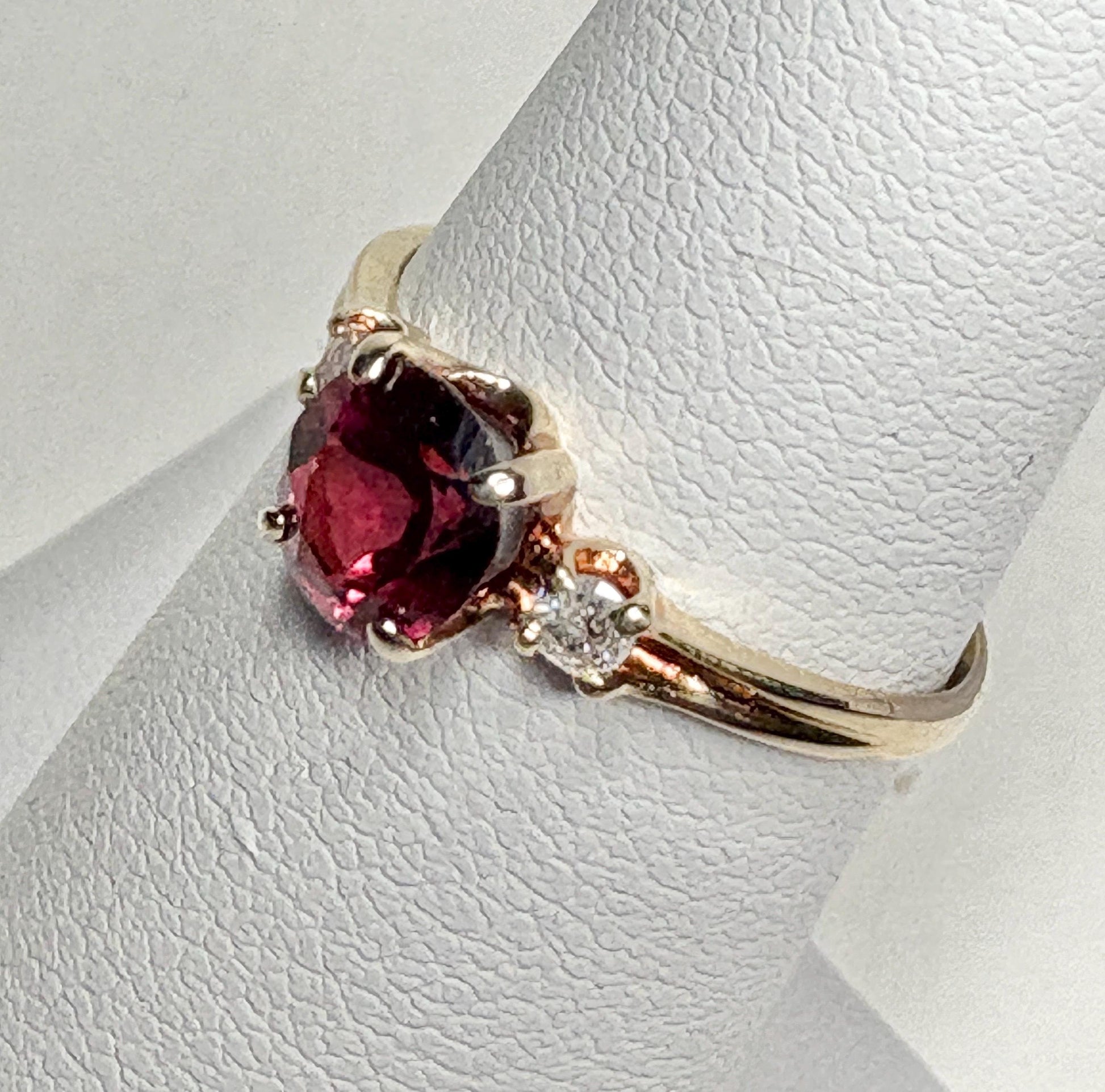Vintage 10k gold ring with a merlot garnet and two small diamonds.