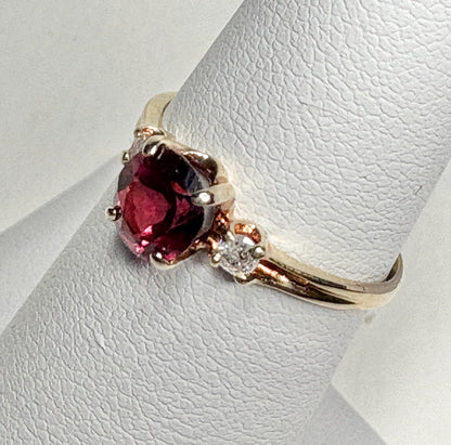 Vintage 10k gold ring with a merlot garnet and two small diamonds.