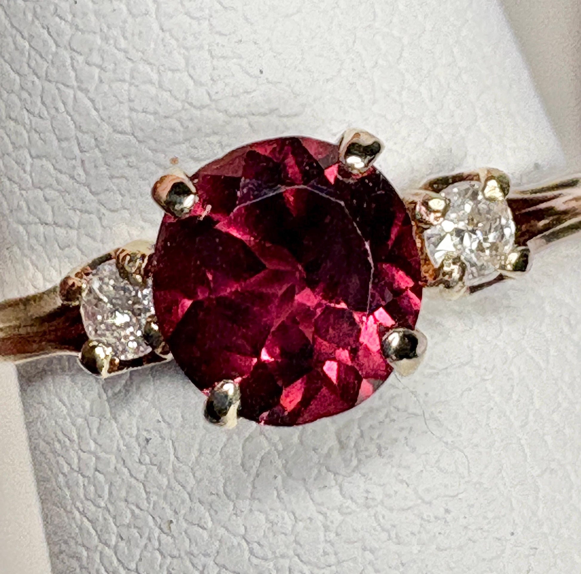 Vintage 10k gold ring with a merlot garnet and two diamonds.