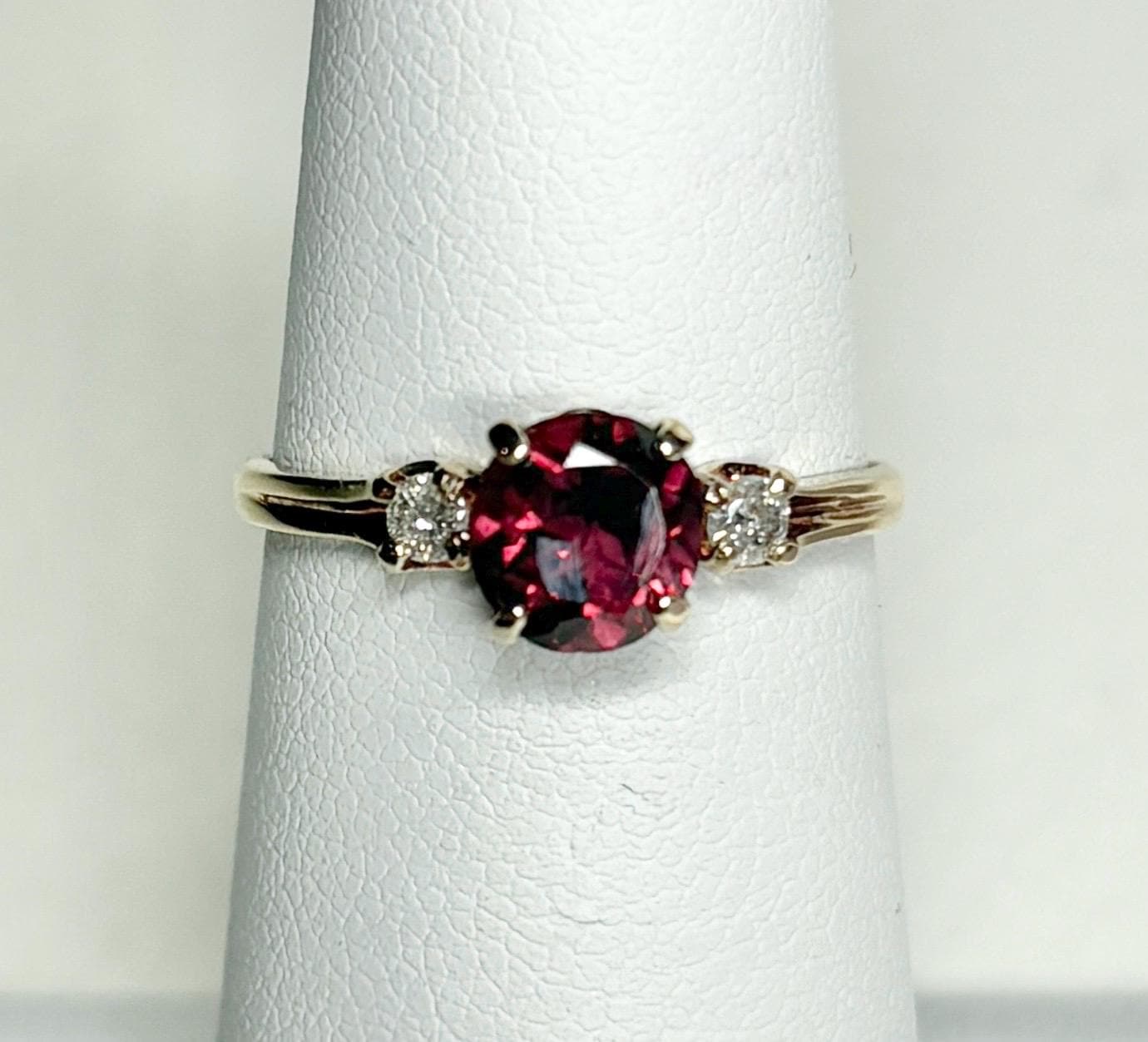 Vintage 10k gold ring with a merlot garnet and two diamonds.