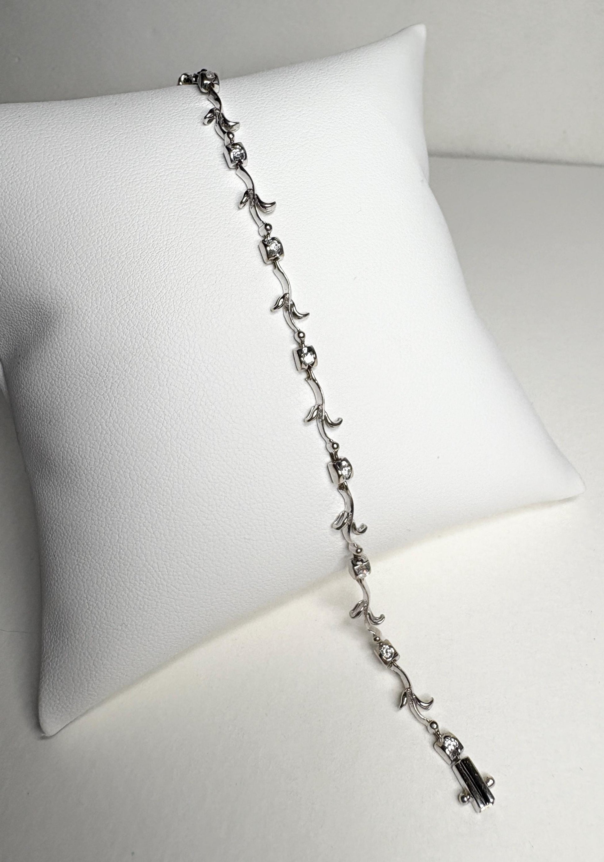 Solid 18k white gold bracelet with natural diamonds and vine links.