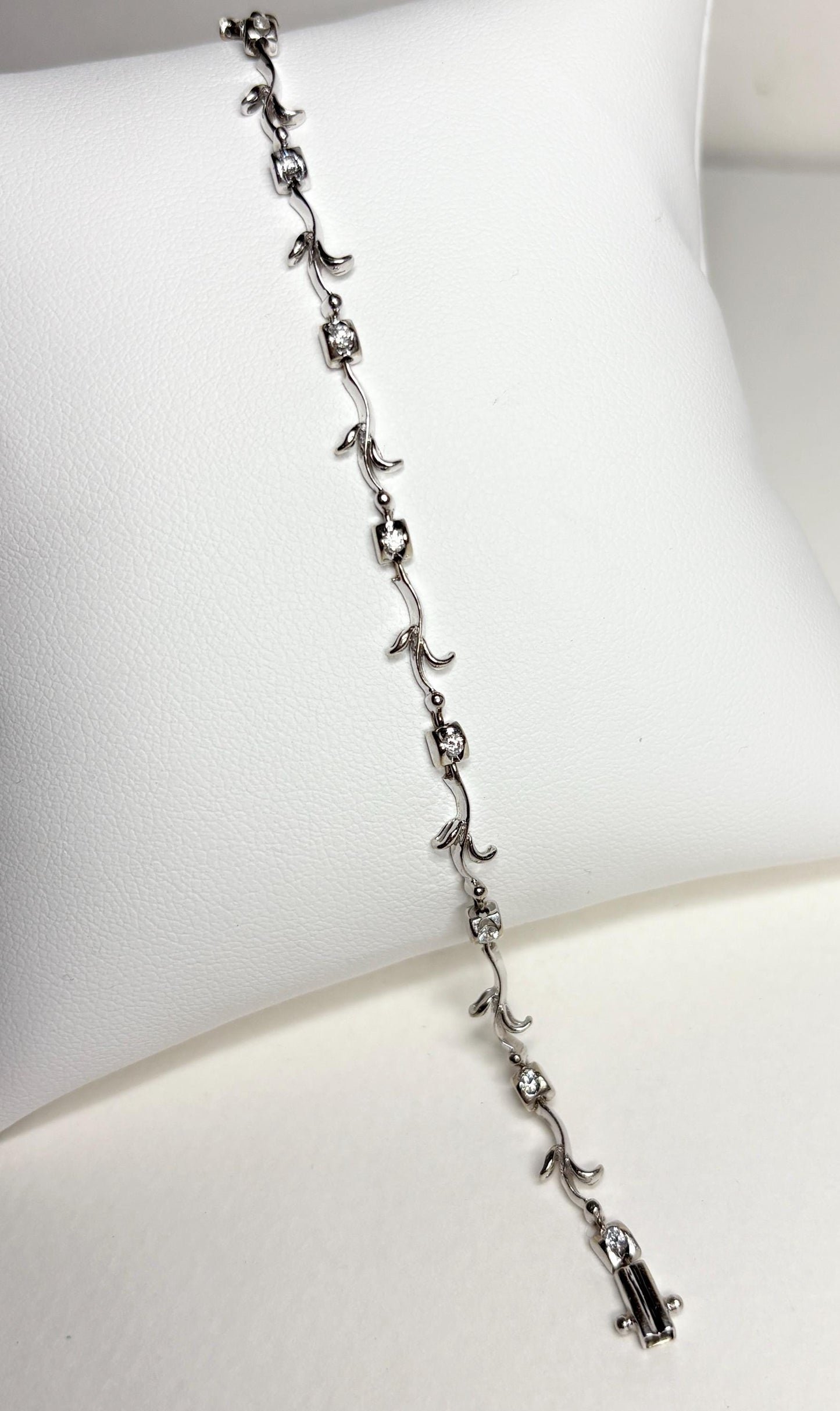 Solid 18k white gold bracelet with natural diamonds and vine links.