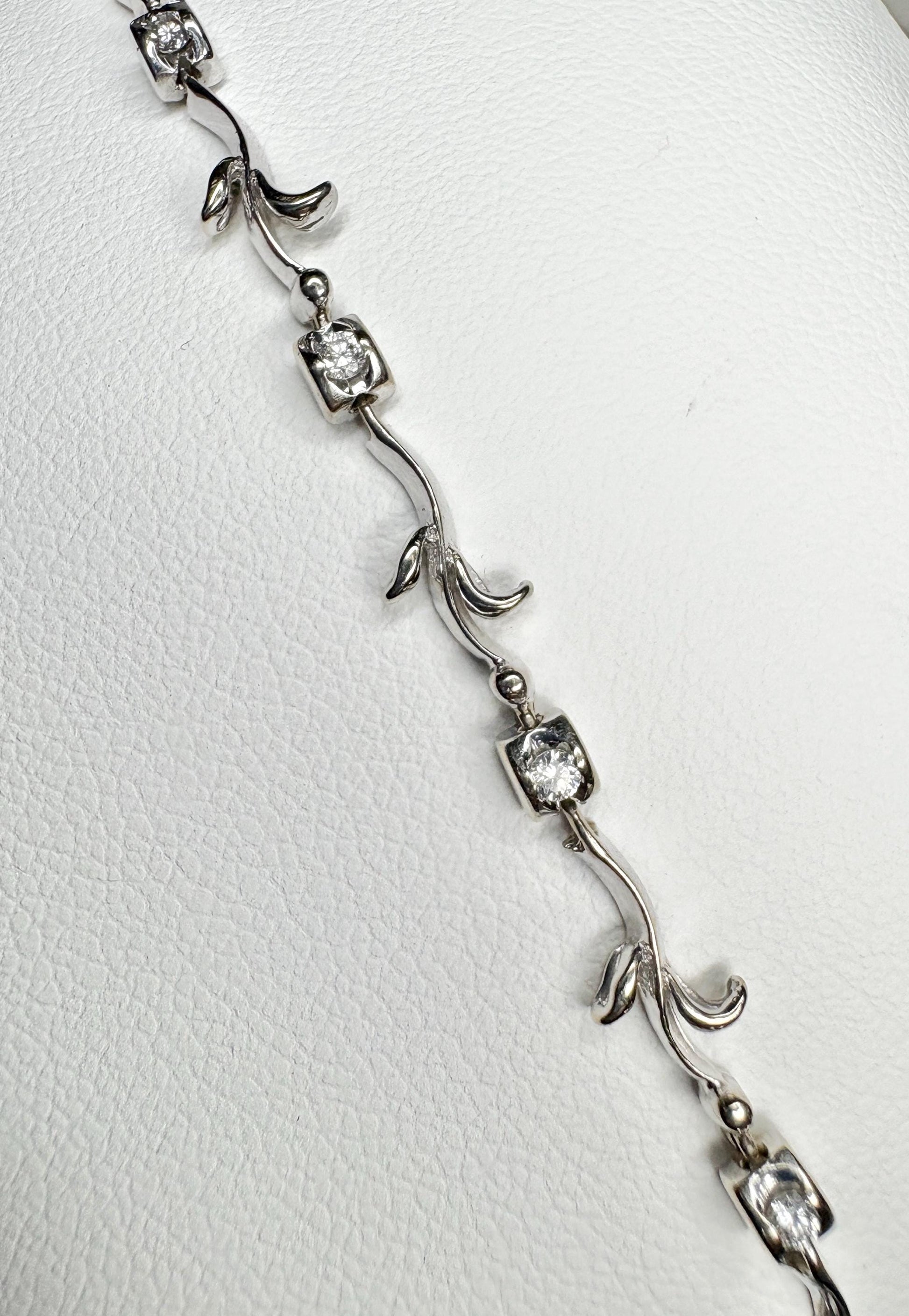 Solid 18k white gold bracelet with natural diamonds and vine-like links.