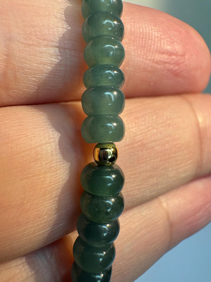 Guatemalan Type A jadeite jade stretch bracelet with gold beads.