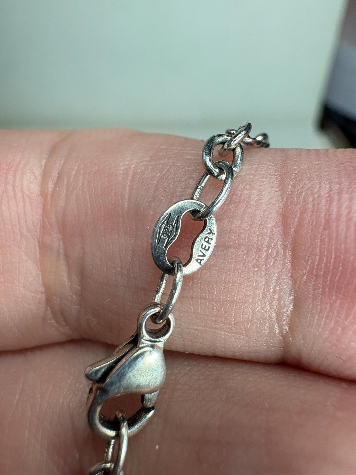 A silver James Avery chain with a lobster clasp and a pendant.