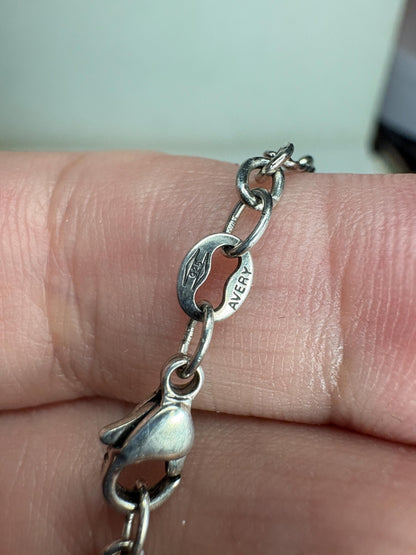 A silver James Avery chain with a lobster clasp and a pendant.