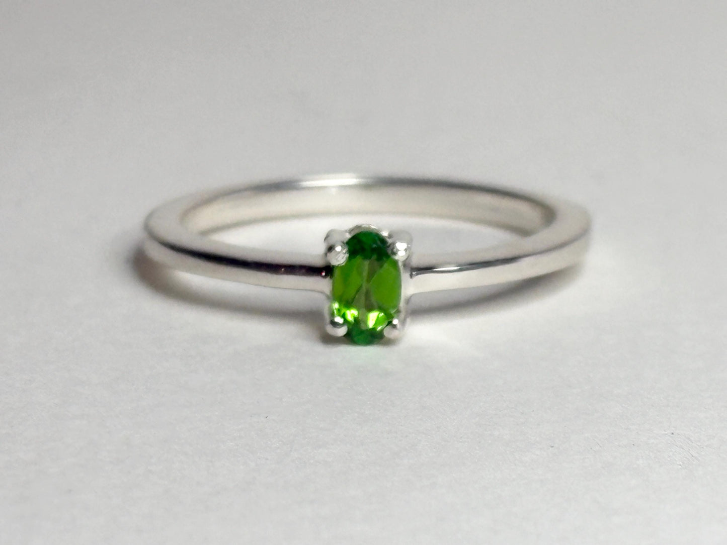 Sterling silver ring with a 3x5mm oval chrome diopside solitaire.