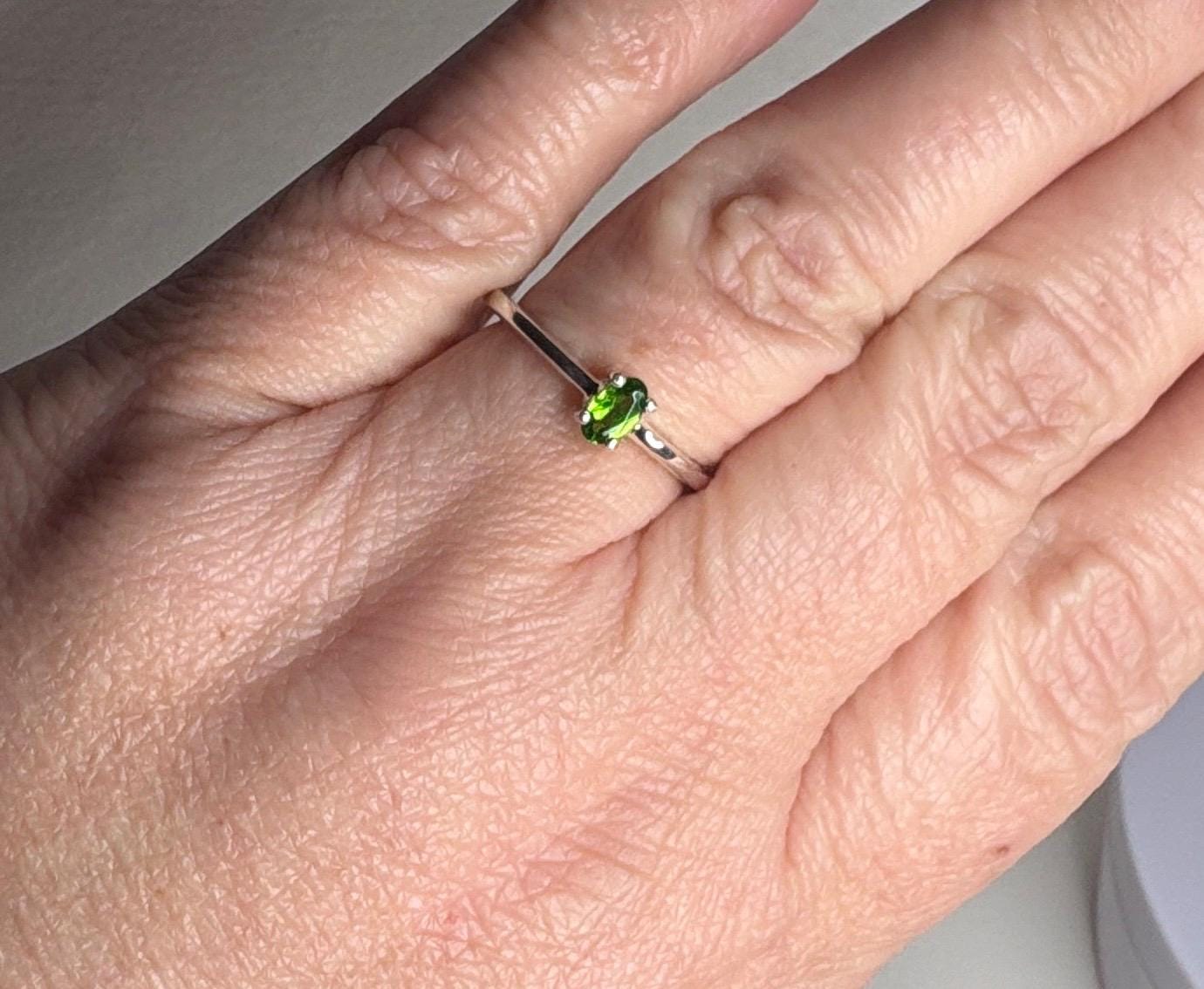 Sterling silver ring with a small oval chrome diopside gemstone.
