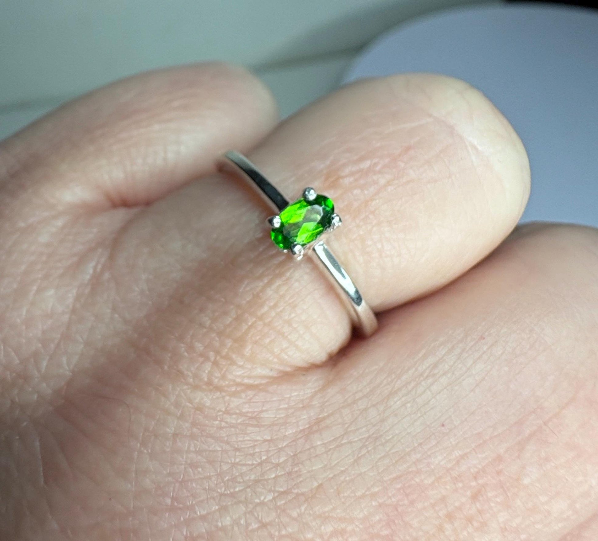 Sterling silver ring with a 3x5mm oval chrome diopside gemstone.