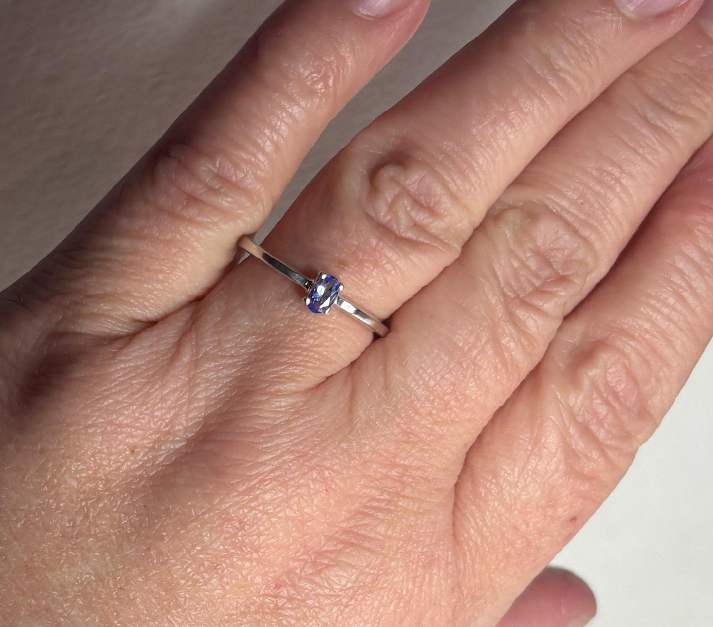 Sterling silver ring with a 5x3mm oval tanzanite gemstone.
