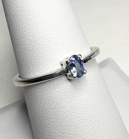 Sterling silver ring with a small oval tanzanite gemstone.