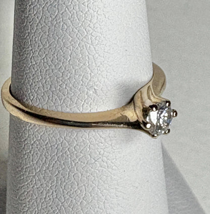 14k gold ring with a .15ct natural diamond in a twist design.