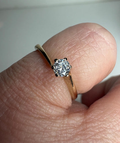 14k gold ring with a .15ct natural diamond in a twist design.