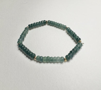 Guatemalan Type A jadeite jade stretch bracelet with gold beads.