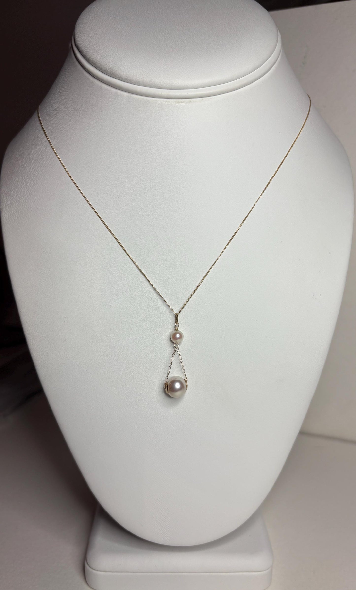 A delicate gold necklace with two Akoya cultured pearls.