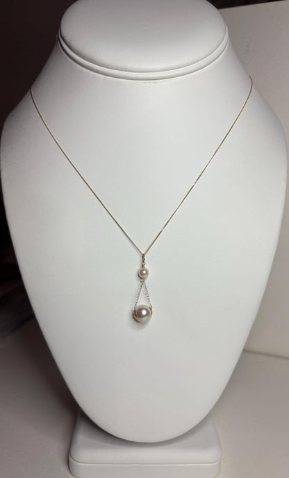 A delicate gold necklace with two Akoya cultured pearls.