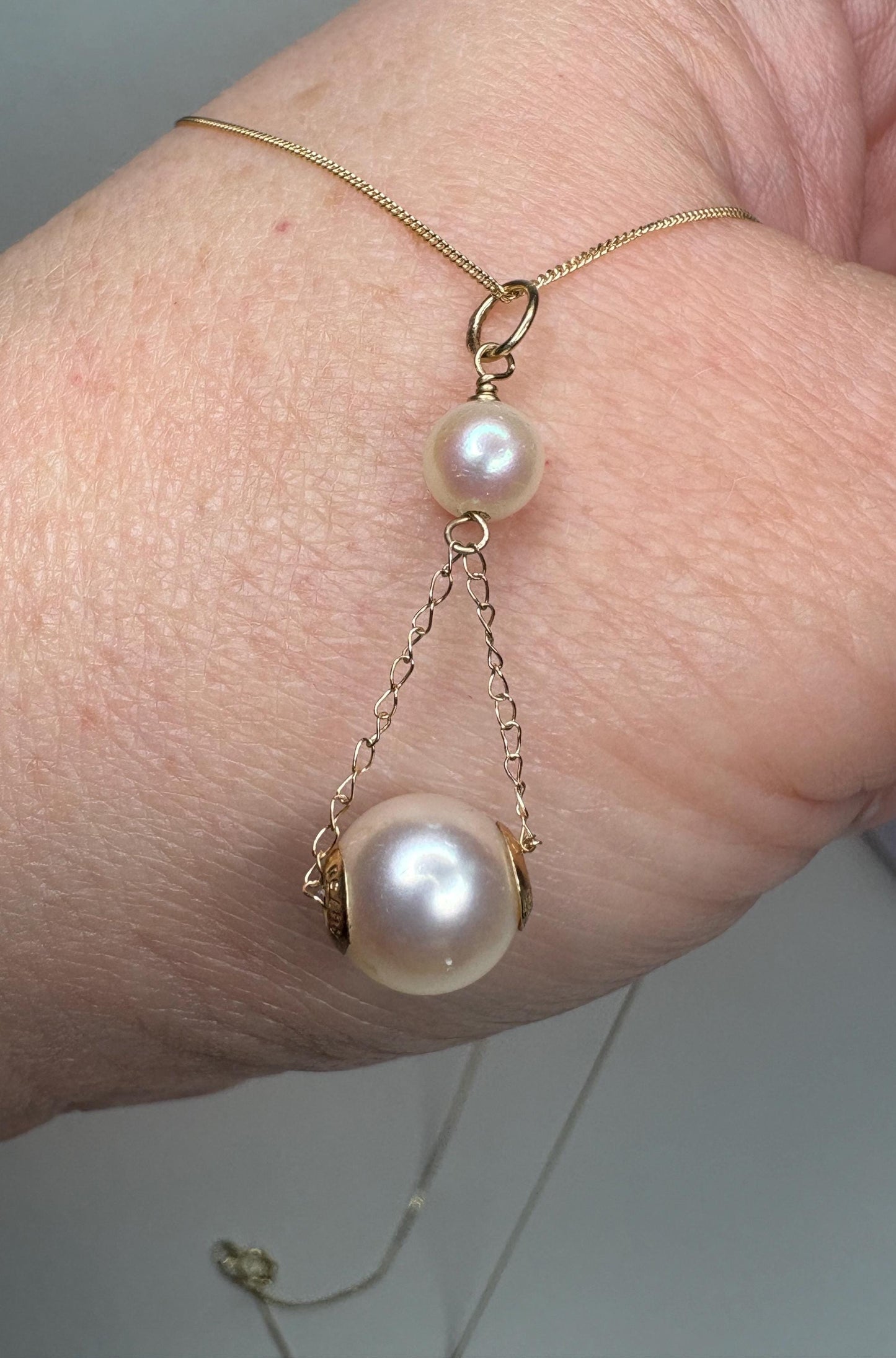 18k, 14k, and 9k gold lavaliere necklace with two Akoya cultured pearls.