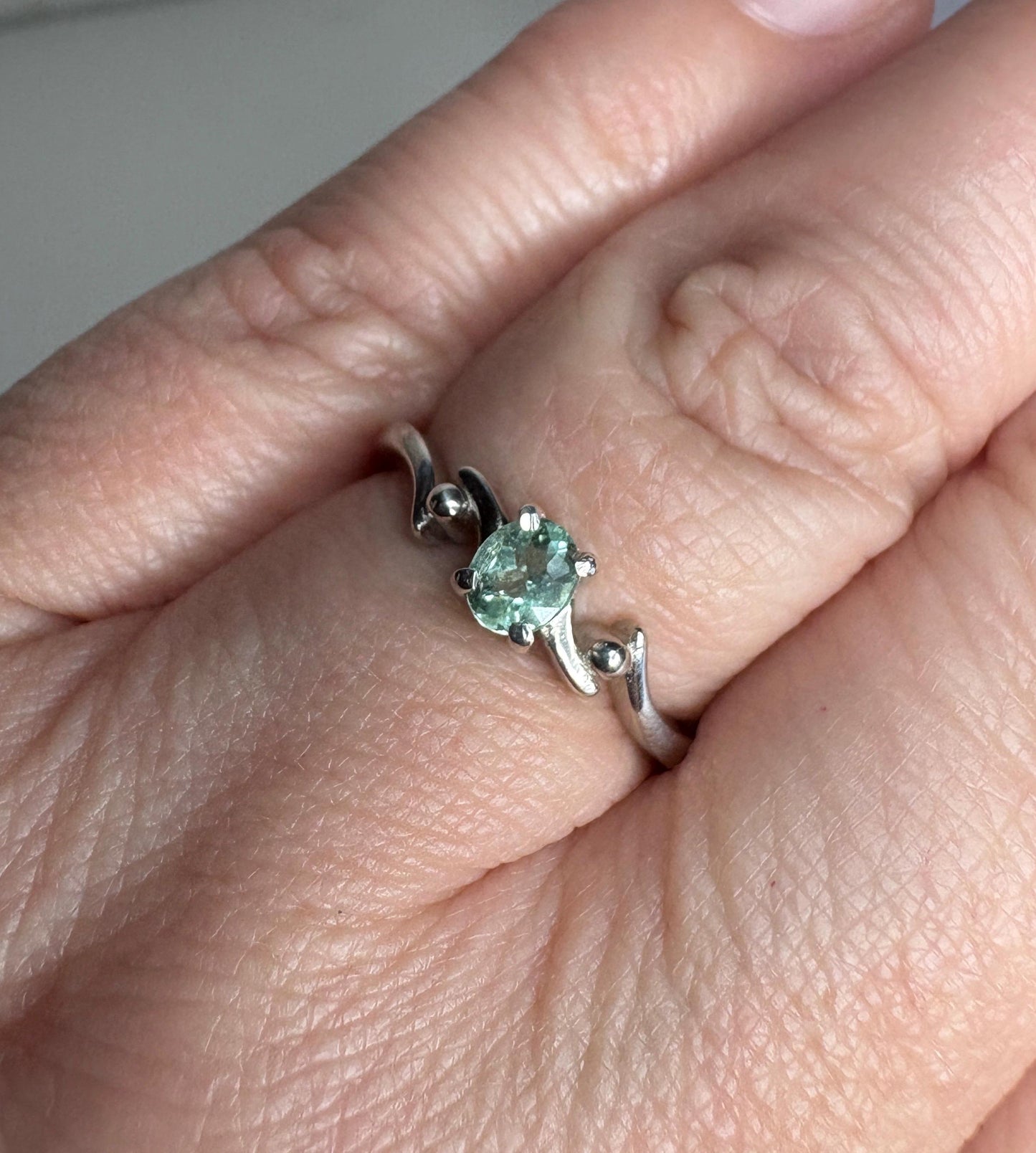 Sterling silver ring with an oval mint green tourmaline gemstone.