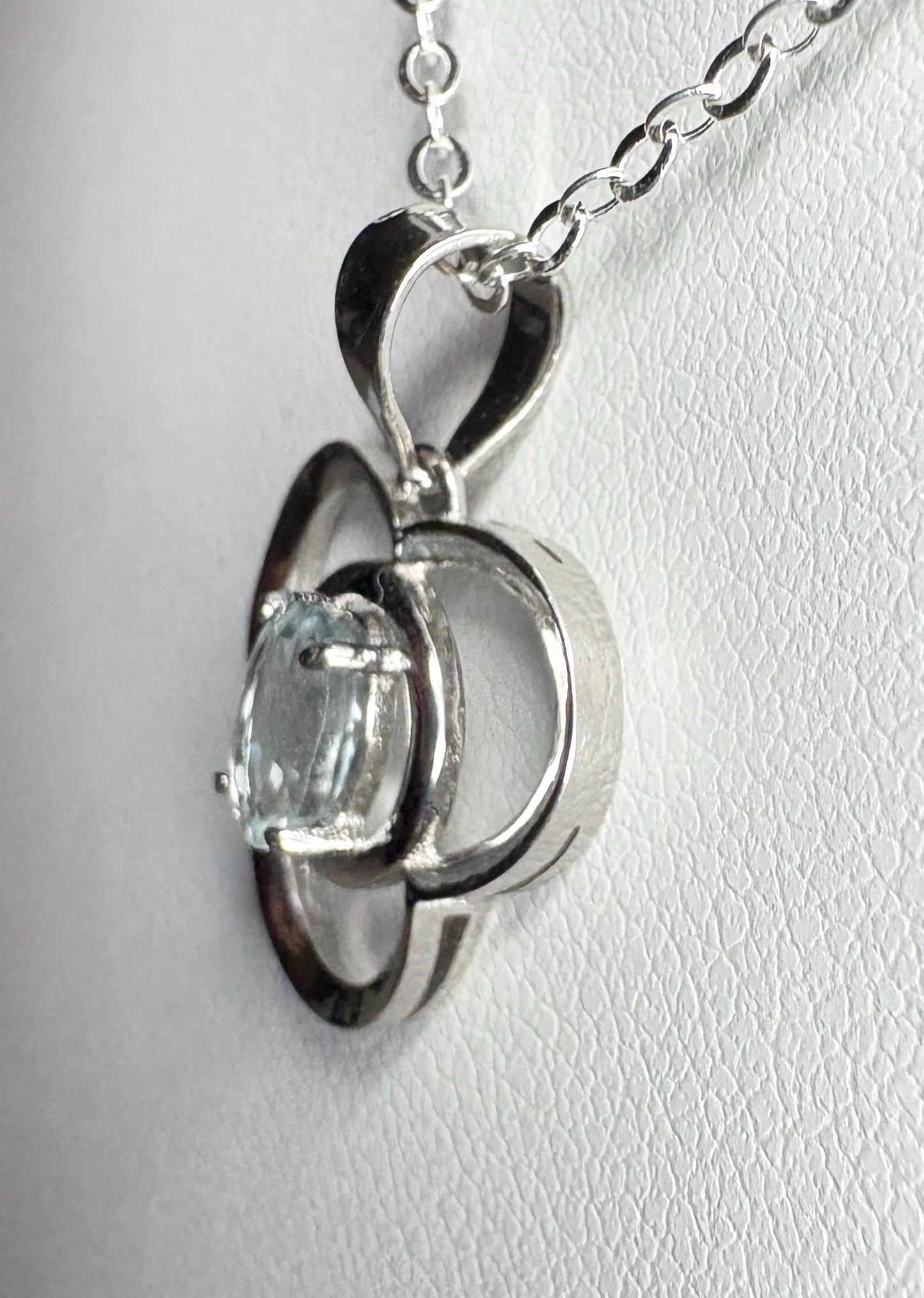 Sterling silver pendant necklace with a light blue oval tourmaline in a clover design.